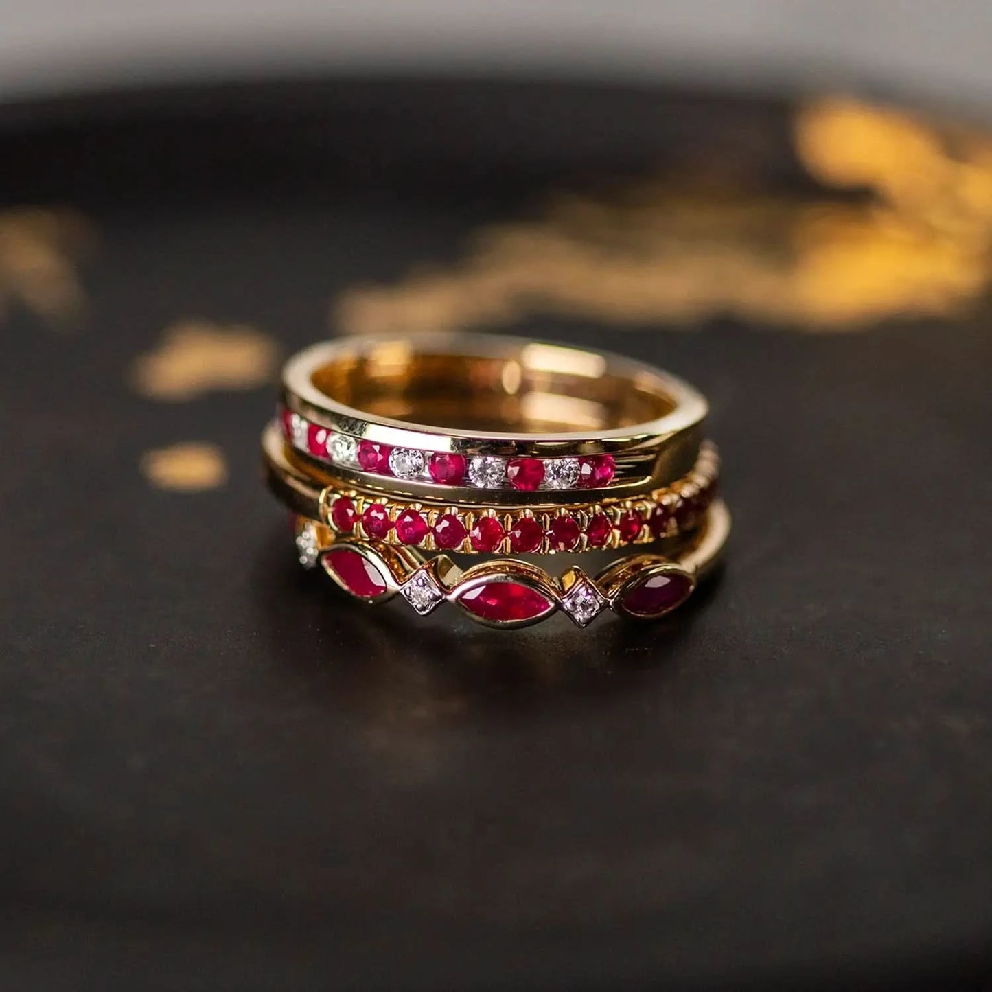 ruby and diamond gold ring stacked with other ruby gold rings