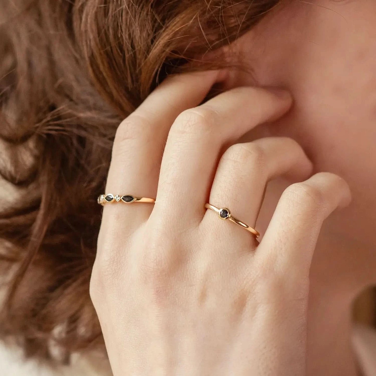 model wearing sapphire gold ring, and sapphire and diamond gold ring