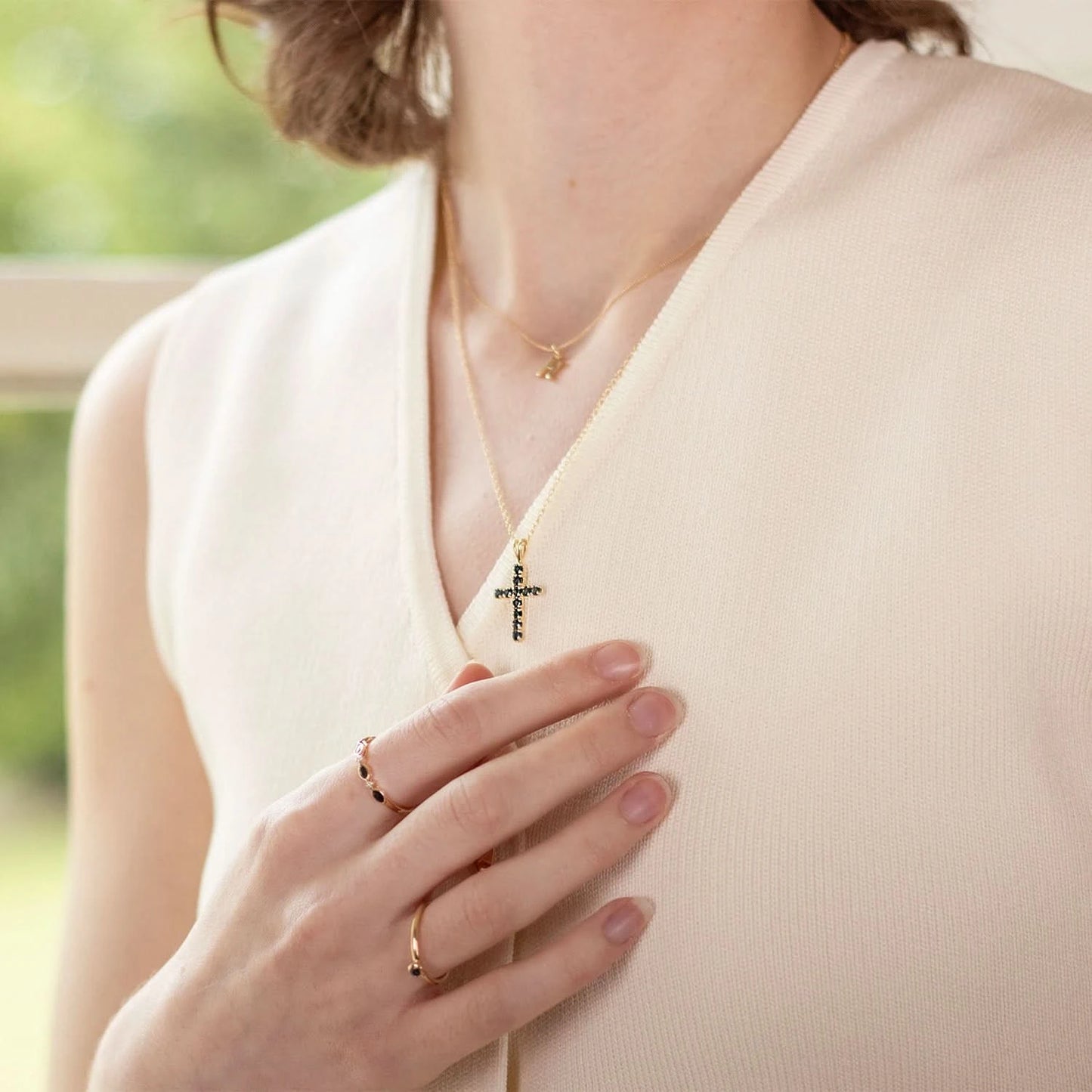model wearing tsavorite cross gold necklace with chain