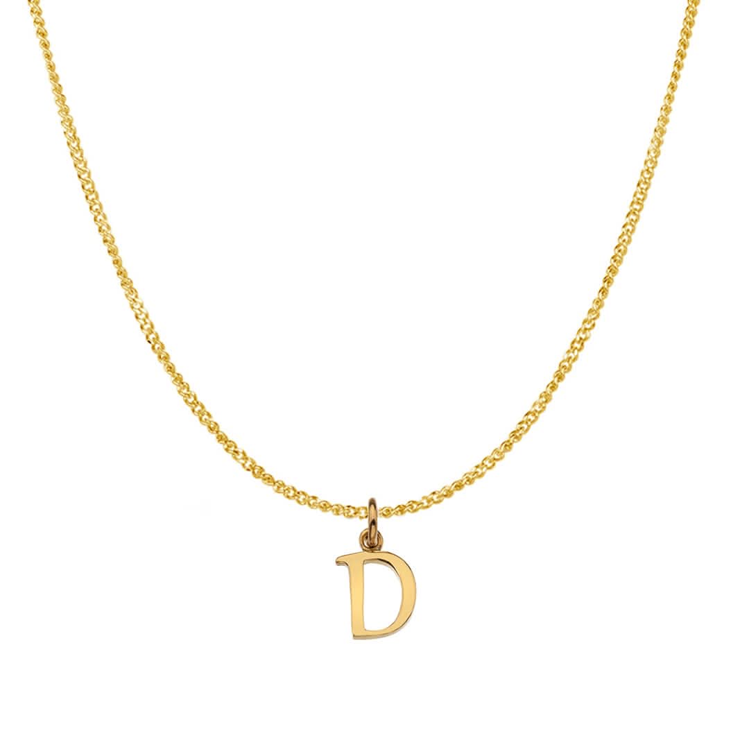 An alphabet initial necklace 'D' in solid 9 carat gold hanging on a solid 9 carat gold close curb chain with a white background