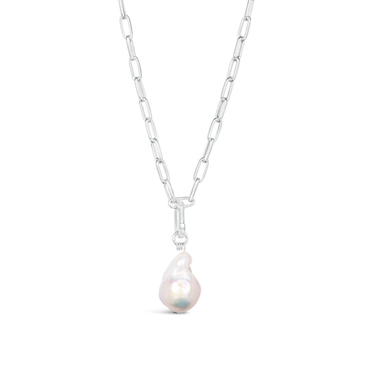 white baroque pearl on silver paperclip chain on white background