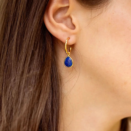 model wearing lapis lazuli gold drop hoop earrings