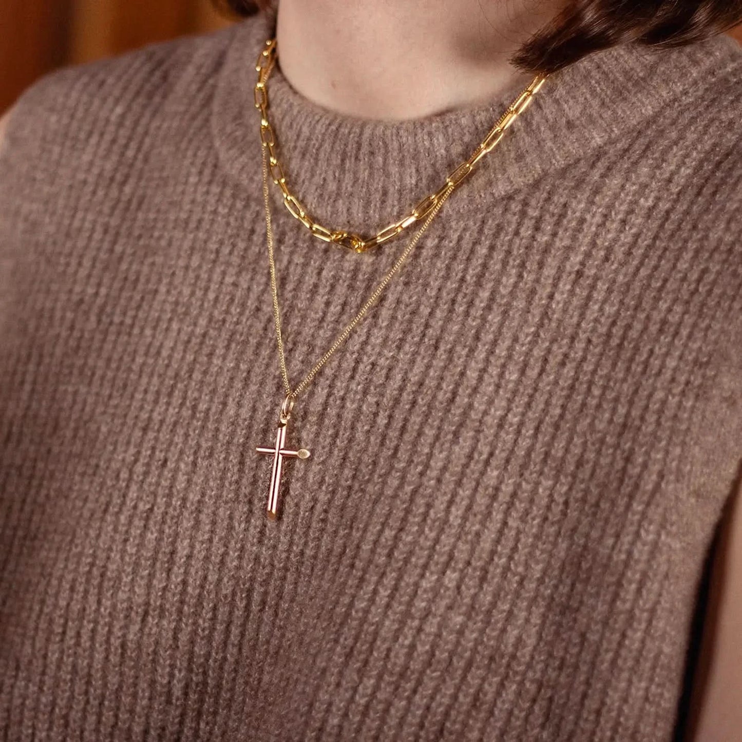 model wearing gold cross necklace with chain