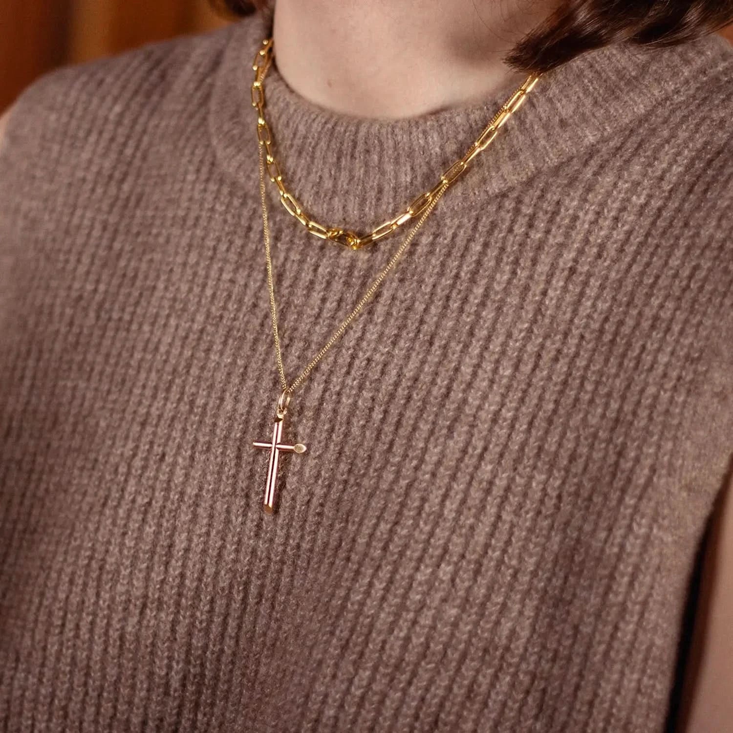 model wearing gold cross necklace with chain