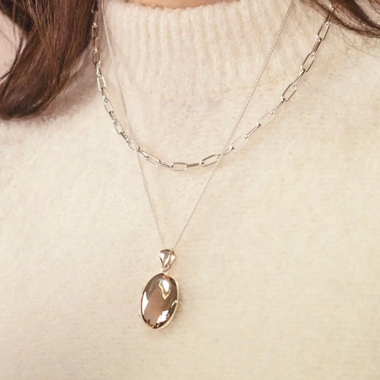 woman wearing Silver oval Necklace for ashes, memorial necklace, locket with one photo and ashes storage, silver curb chain, engraving, silver paperclip chain