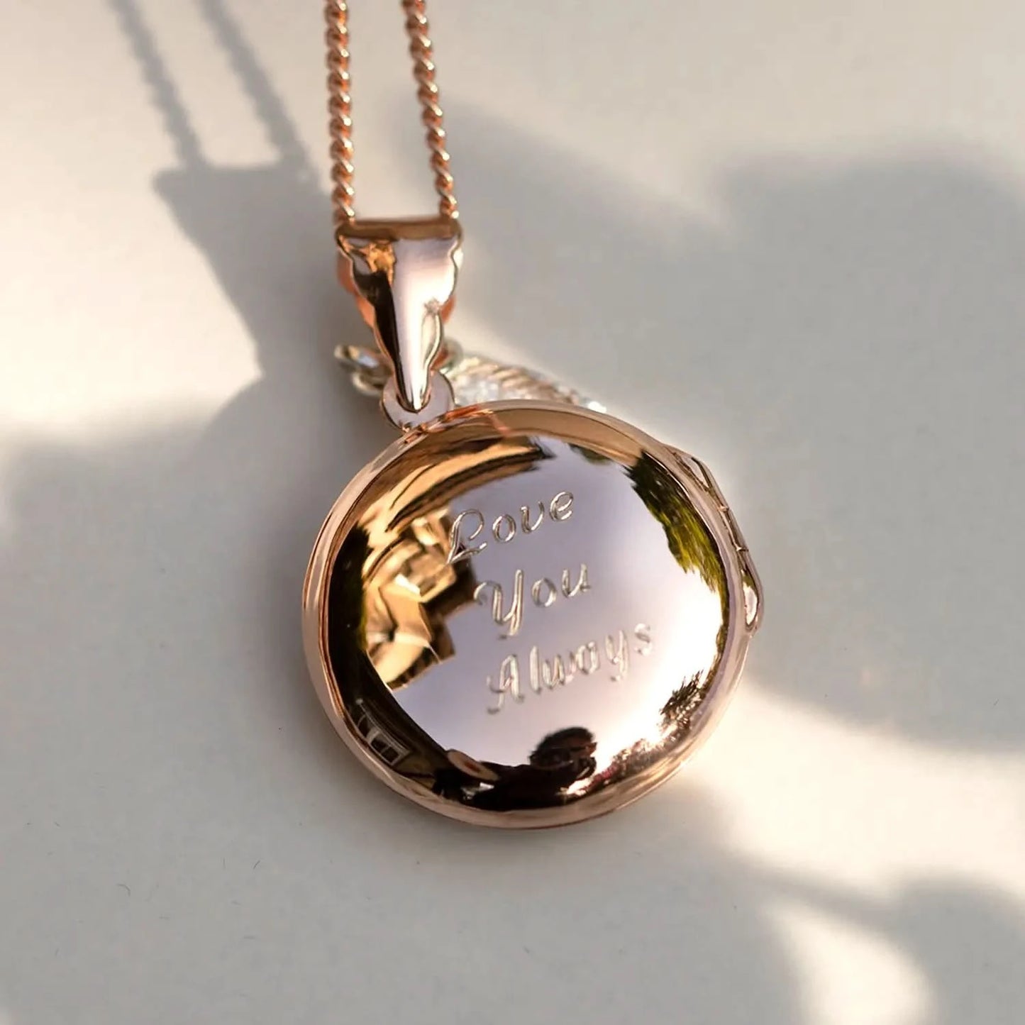 Rose gold round photo locket engraved with ‘Love You Always’ on chain
