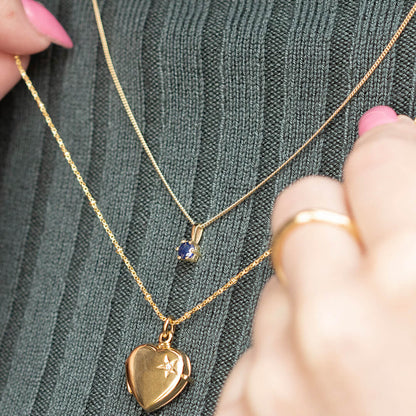 sapphire solataire necklace by Lily Blanche layered with a gold diamond heart locket
