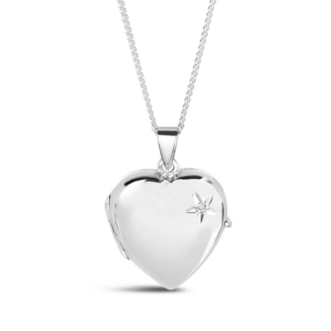 closed silver heart locket on a delicate silver curb chain. The locket has a genuine diamond stone in it's corner.