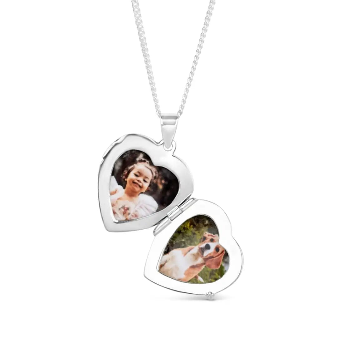 silver heart locket open showing two photographs inside