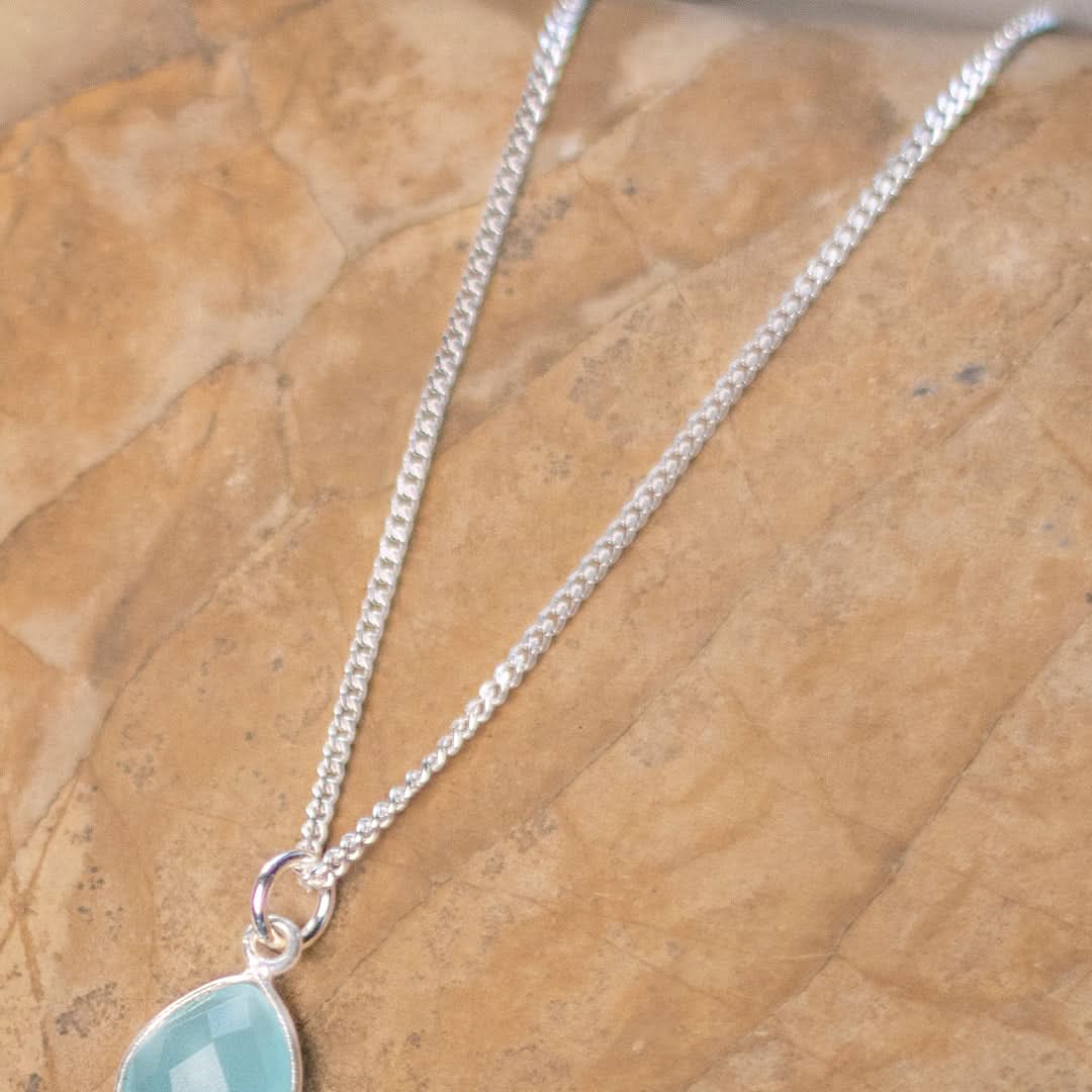 white gold curb chain on flatlay surface