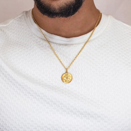 Gold st Christopher necklace with a pendant worn by a man in a white shirt