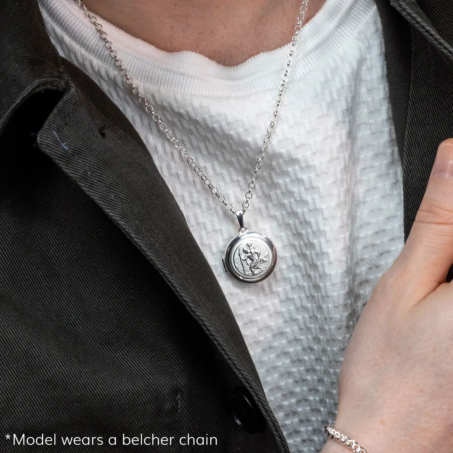 photograph of st christopher locket in silver showing the front of the locket on a male model