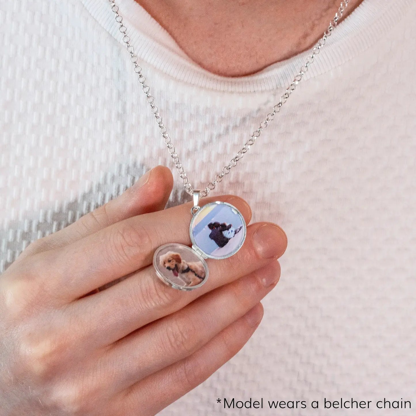 photograph of a silver and gold st Christopher locket, the locket is open and shows two photos inside. The locket is worn by a man