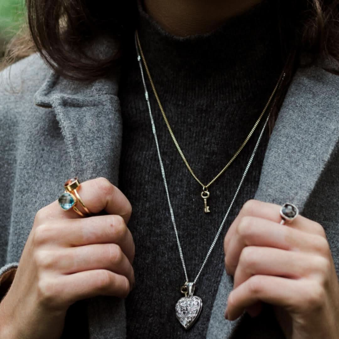 model wearing three cocktail rings in gold with different gemstones