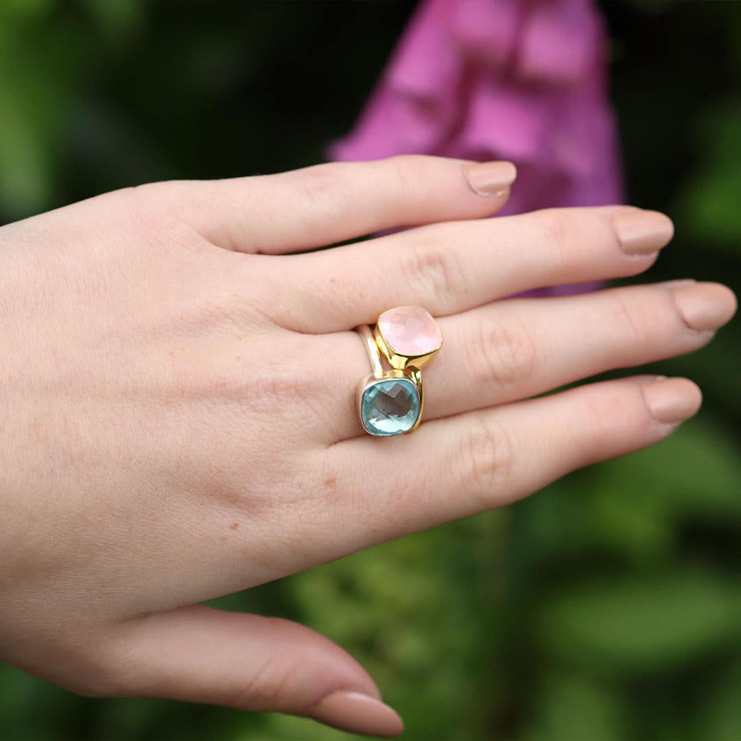model wearing blue topaz cocktail ring in silver