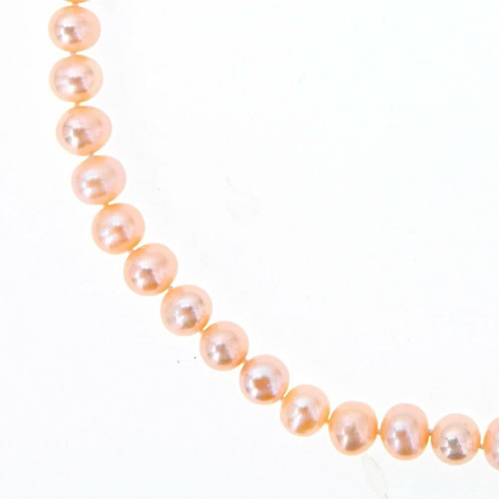 classic pearl necklace in champagne on a white background