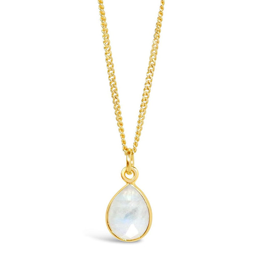 white quartz charm necklace in gold on a white background