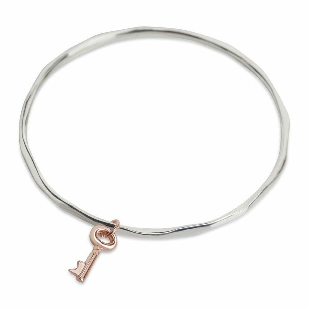 silver bangle with rose gold rose gold key charm