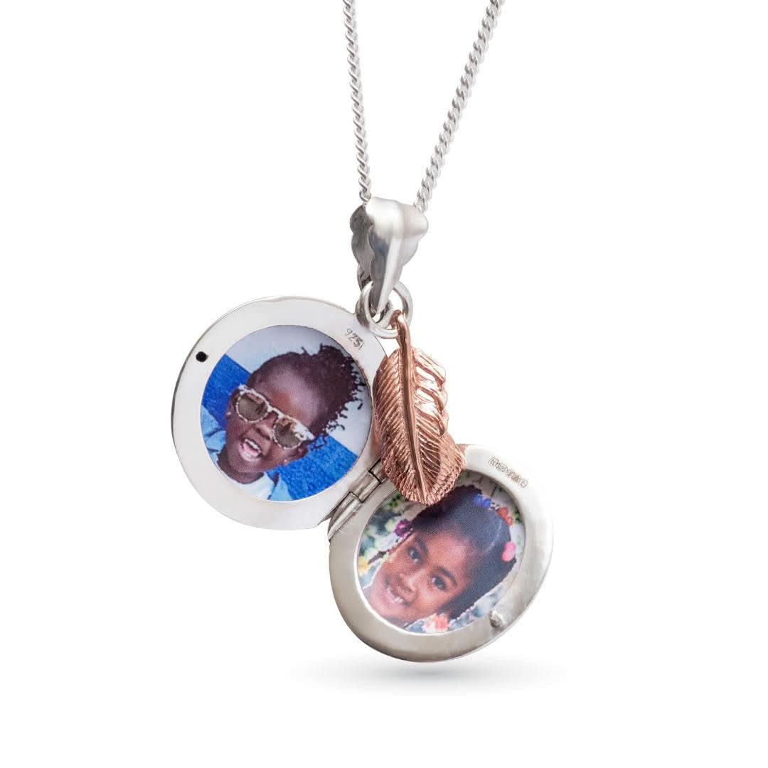 opened white gold feather locket with rose gold feather charm on a white background