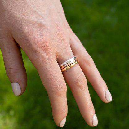 model wearing rose gold, silver and gold friendship band rings