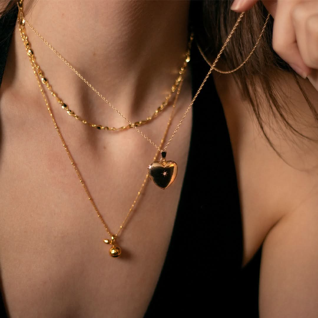 model wearing diamond heart locket in gold