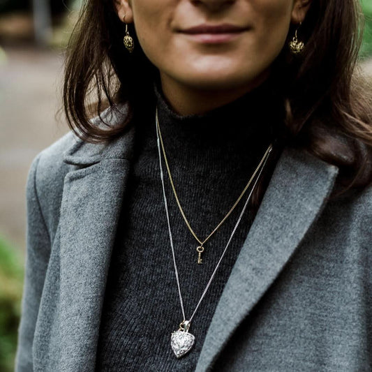 model wearing key pendant in gold