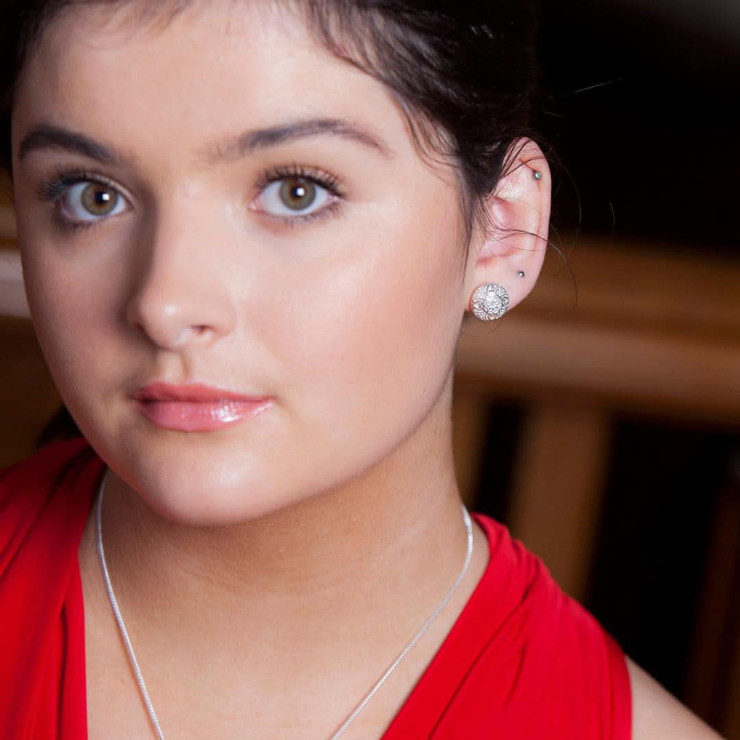 model wearing memory keeper earrings in white gold