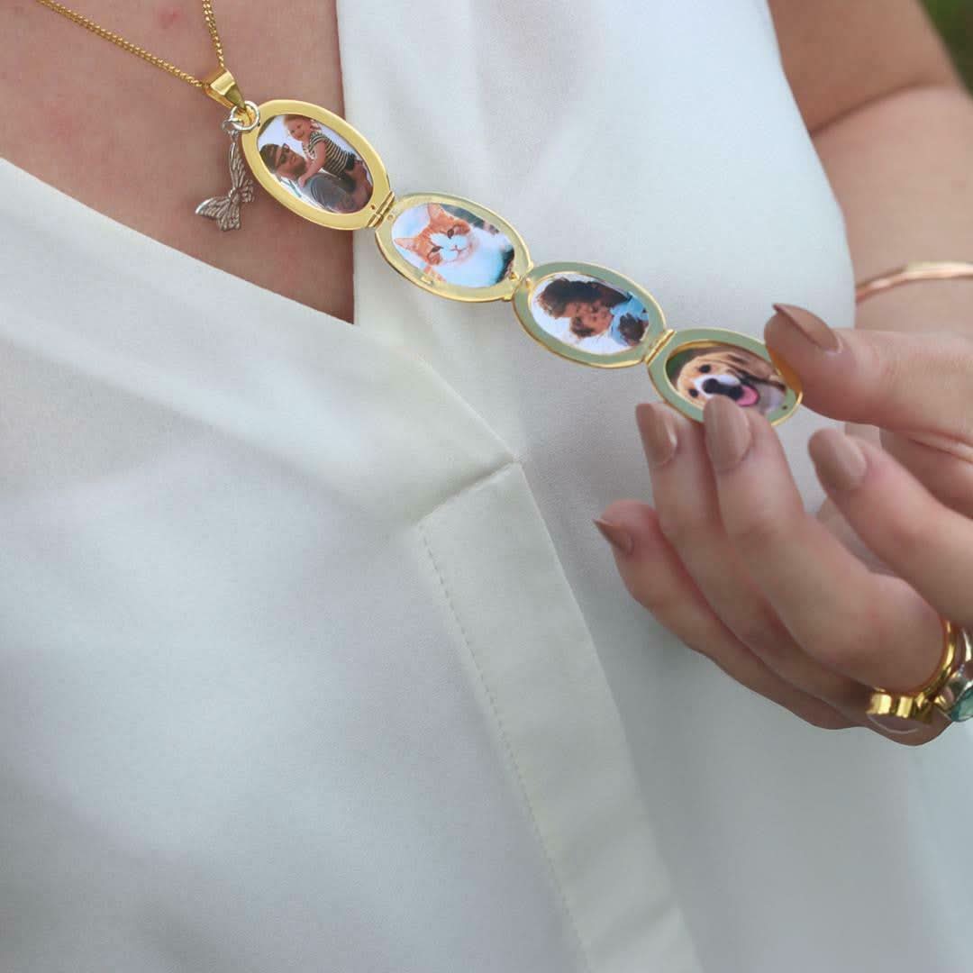 model holding gold oval shaped locket with four photos