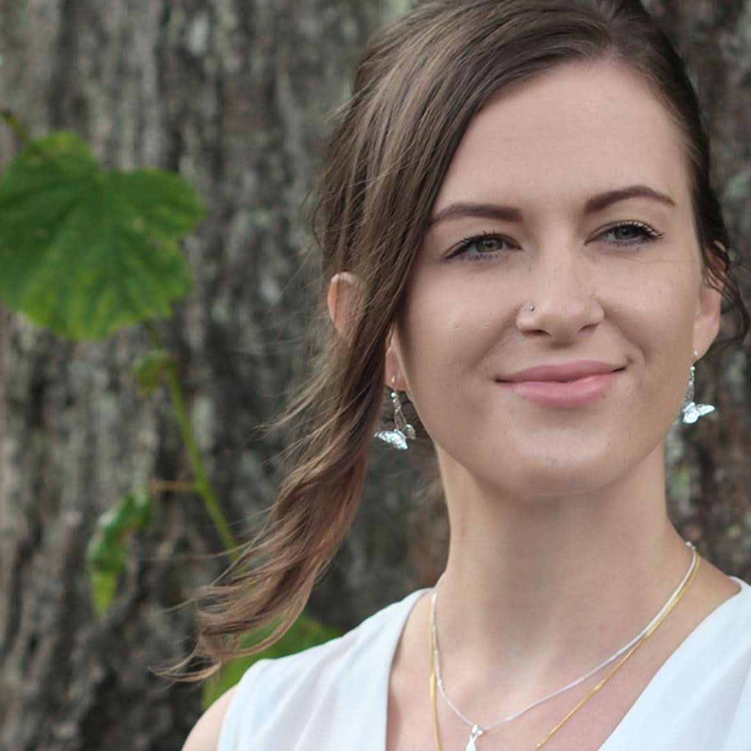 model wearing silver butterfly earrings