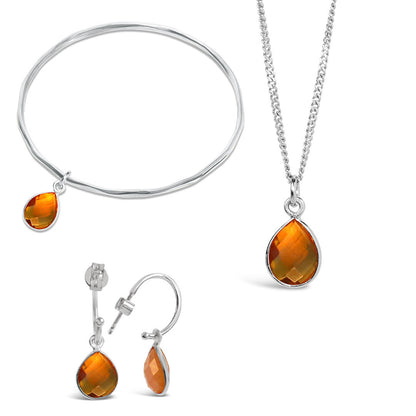 silver citrine charm bangle, necklace and drop hoop earrings on a white background