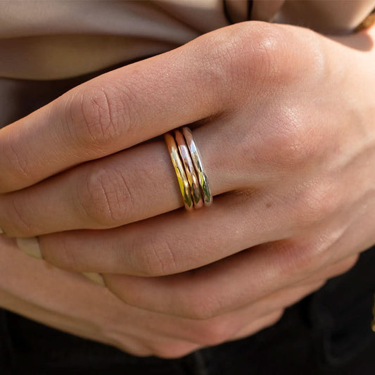 model wearing rose gold, silver and gold friendship band rings