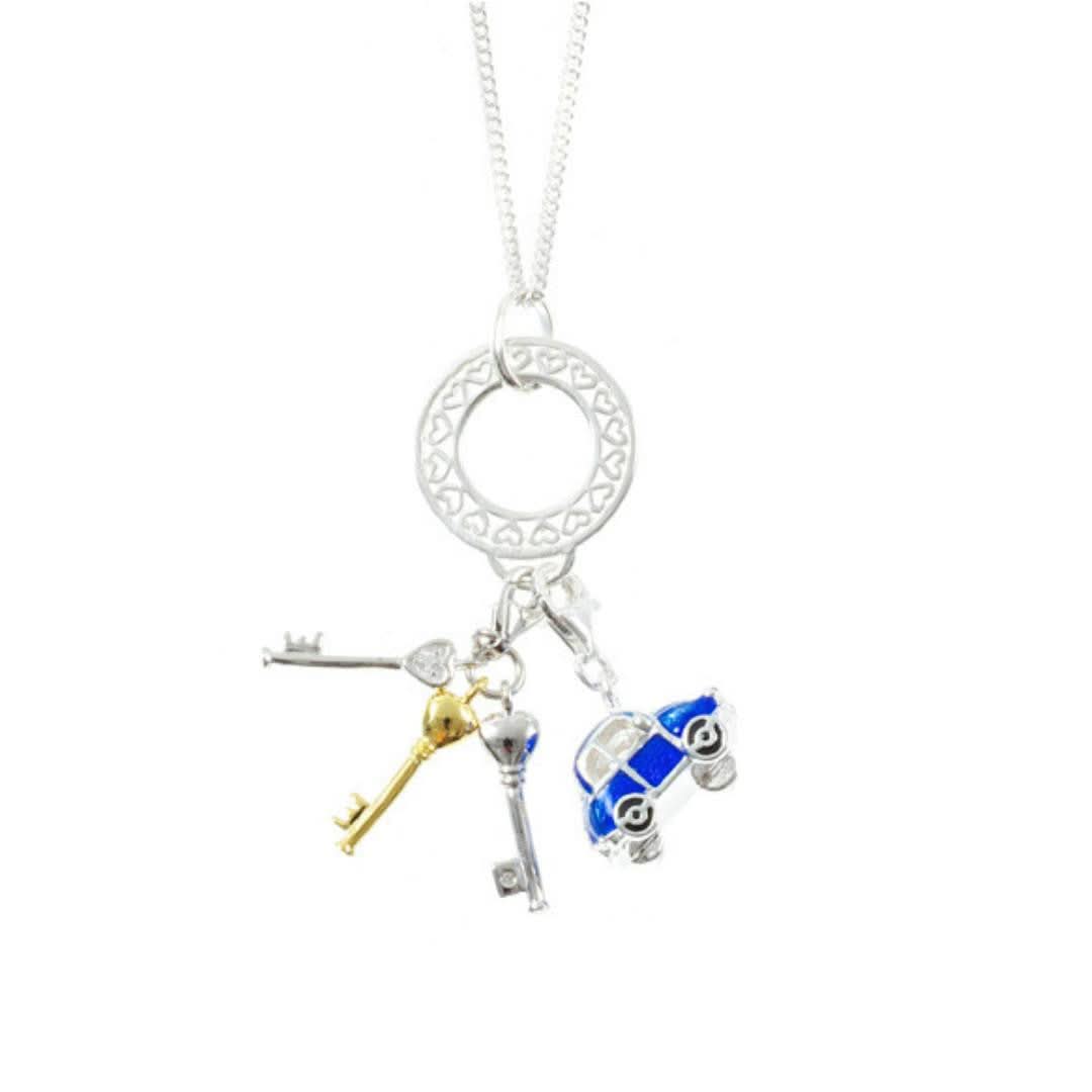 coming of age charm attached to silver charm carrier along with beetles car charm