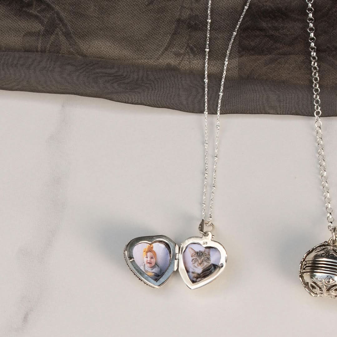 white gold beaded chain with white gold vintage style heart locket and two photos