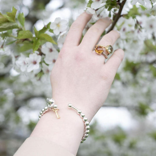 close up of model wearing citrine cocktail ring in silver