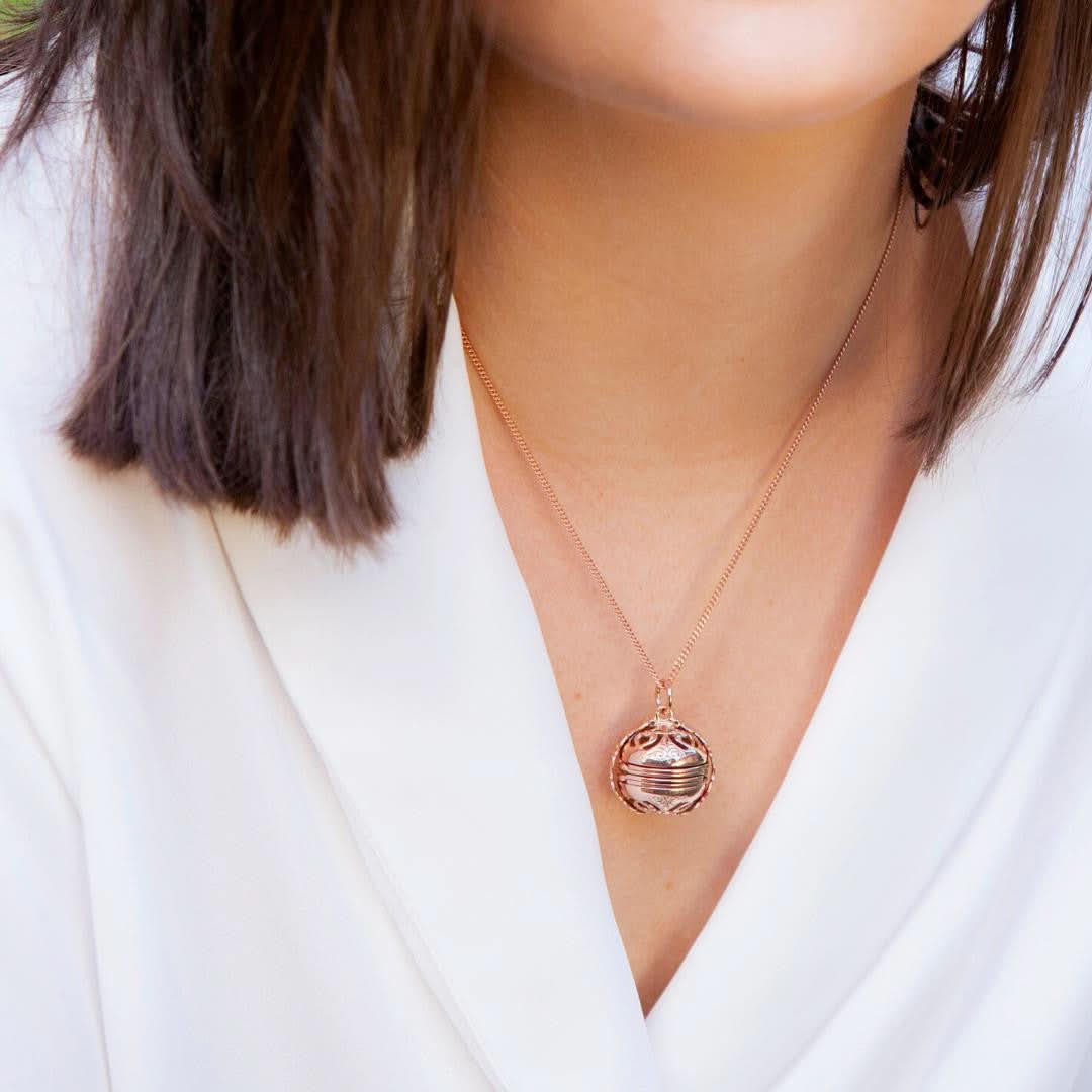 model in white top wearing rose gold memory keeper locket