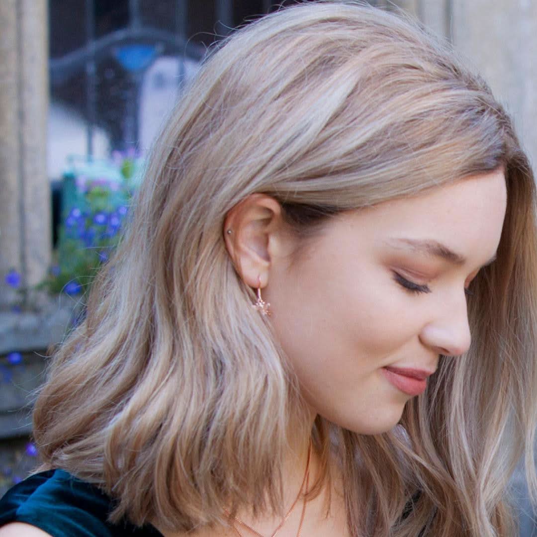 model wearing gold bee earrings