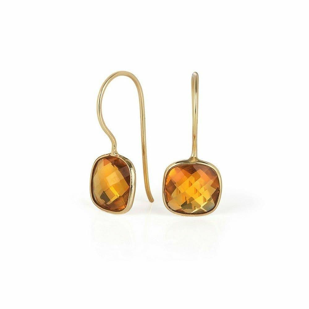 gold citirne earrings on a white background