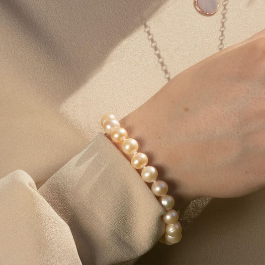 close up of model wearing classic pearl bracelet in champagne