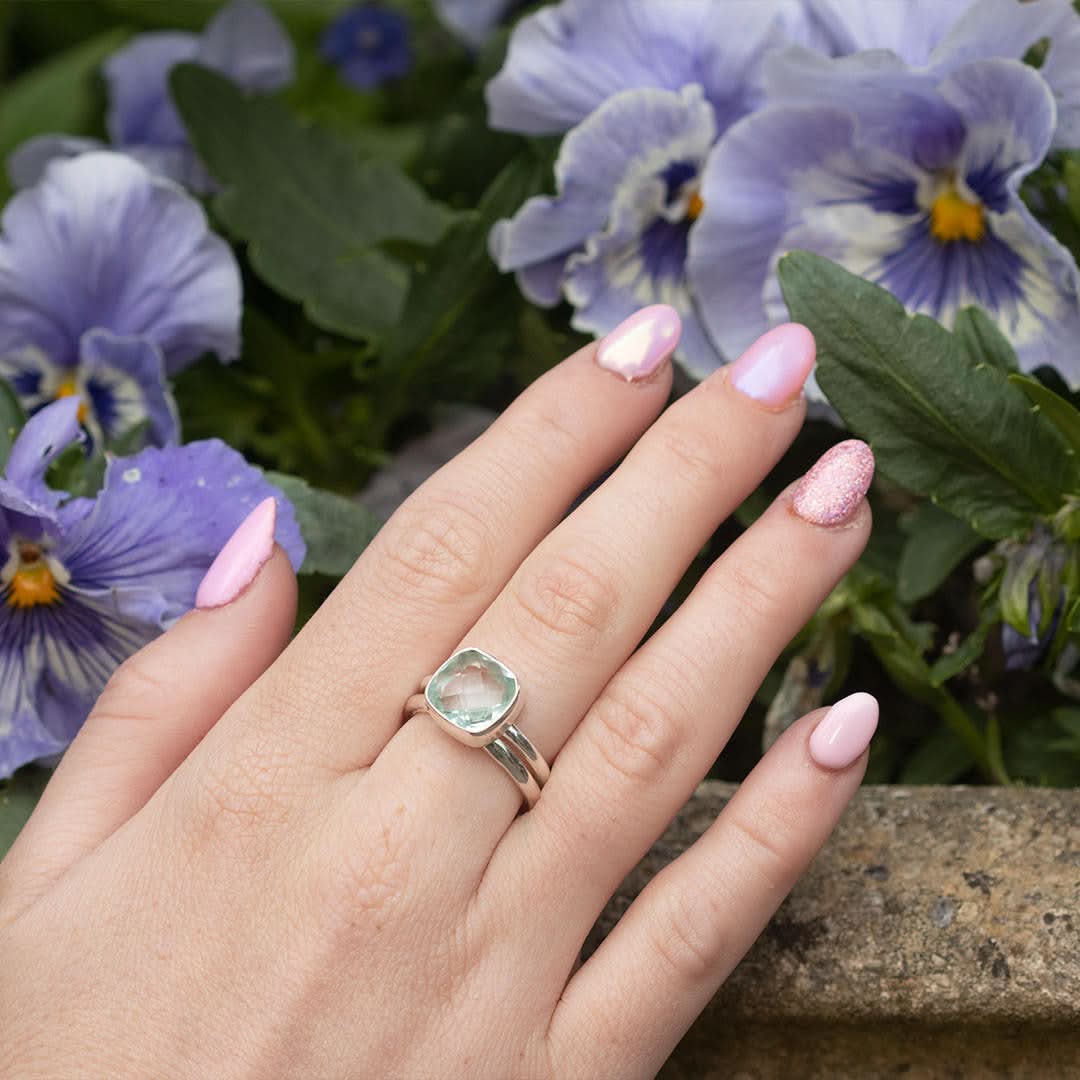 model wearing blue topaz cocktail ring in silver