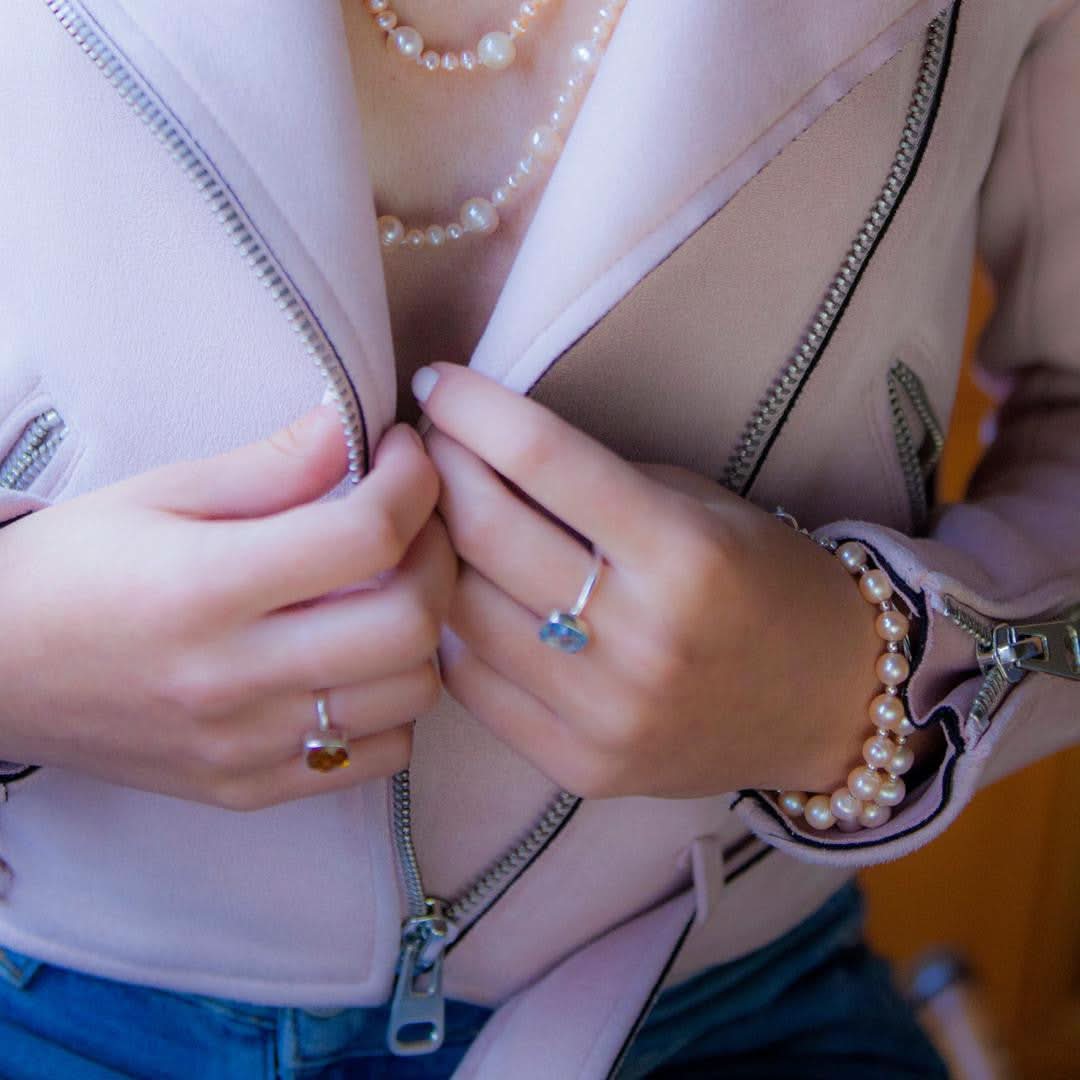 model wearing two classic pearl bracelets in champagne