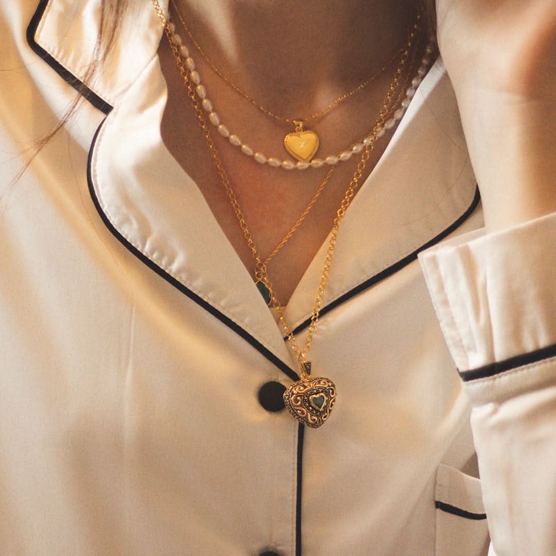 women modelling emerald vintage heart locket in gold