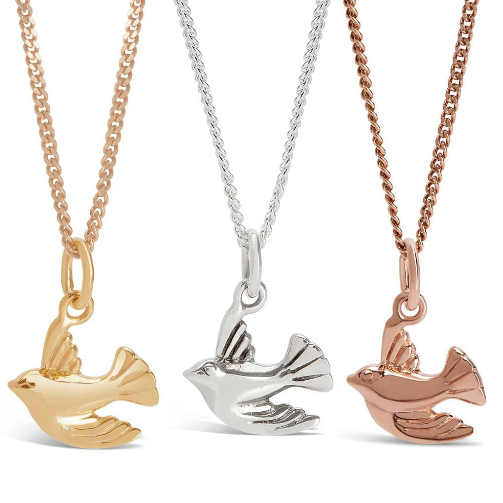 bird pedants in gold, rose gold and silver on a white background