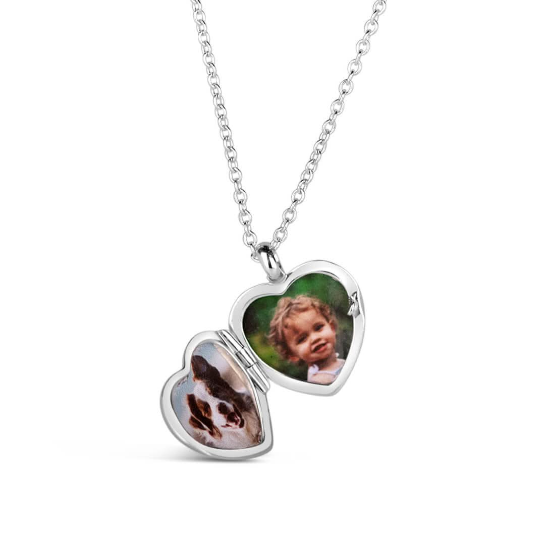 front on view of an opened heart shaped locket in silver on a white background