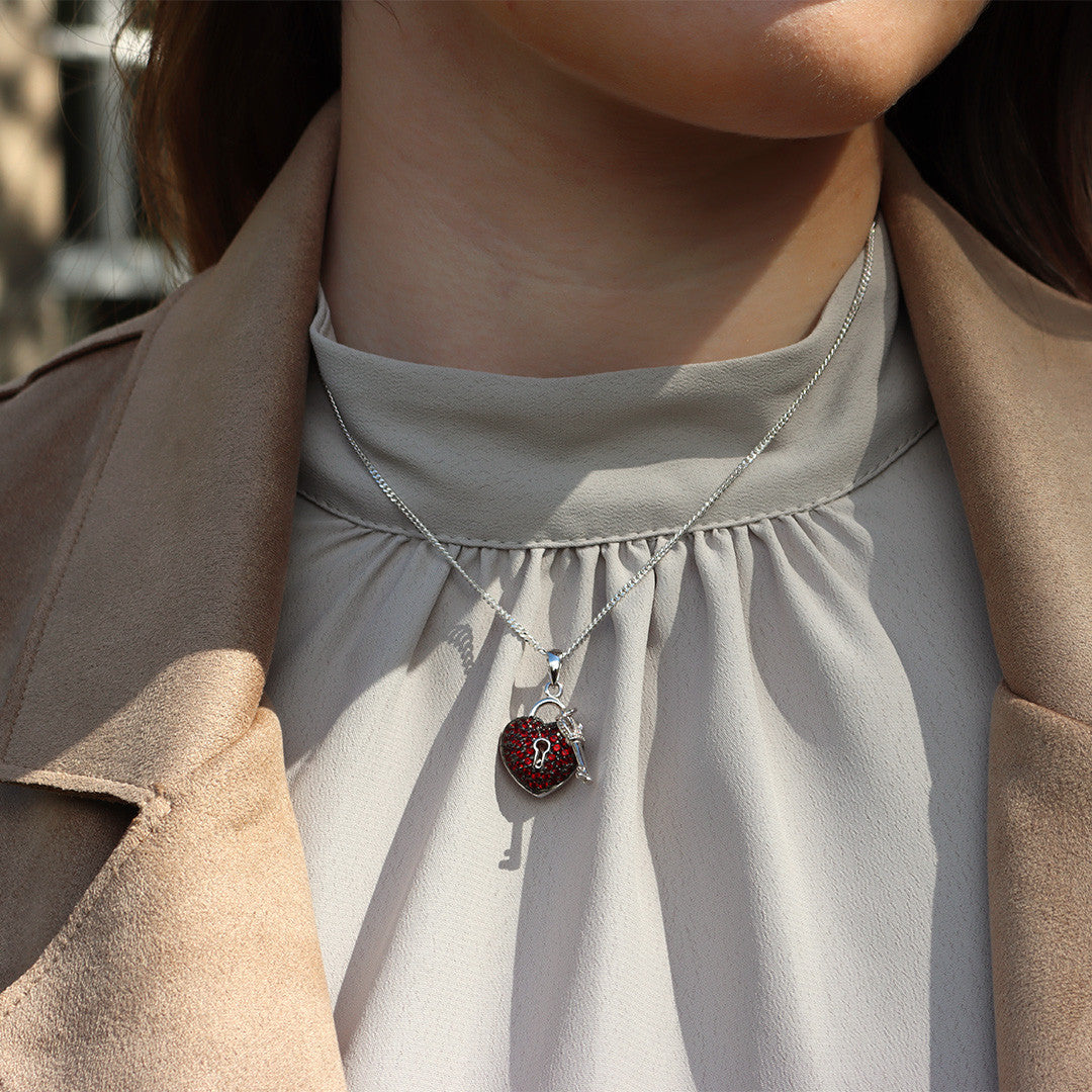 close up of model wearing key to my heart pendant in red