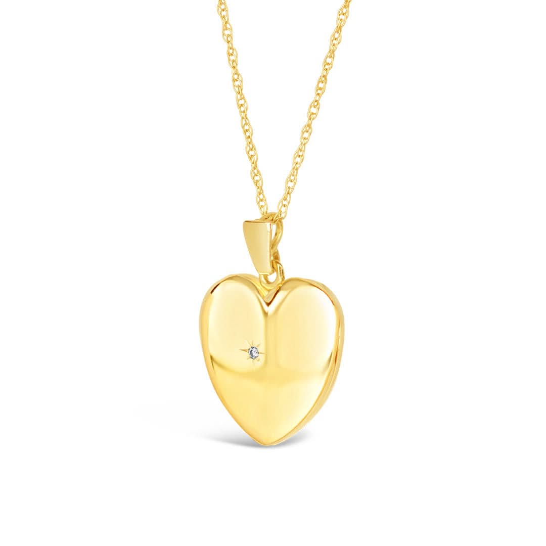 diamond heart locket in gold on a white background