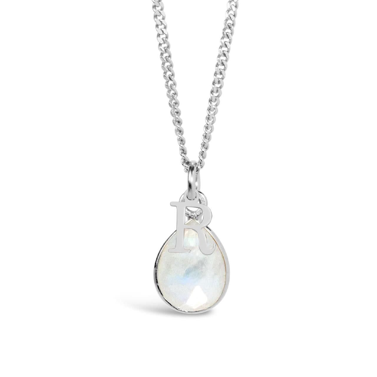 white quartz charm necklace in silver on a white background