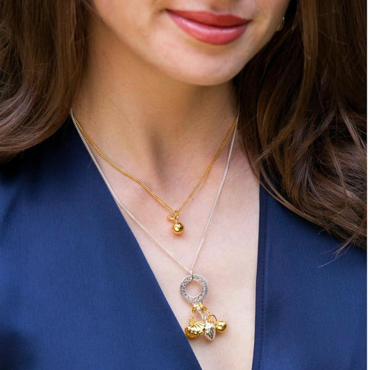 model wearing multiple magical charm necklaces