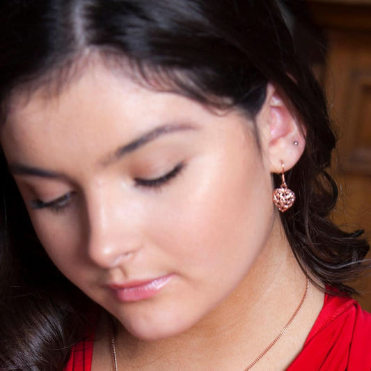 model wearing heart earrings in rose gold