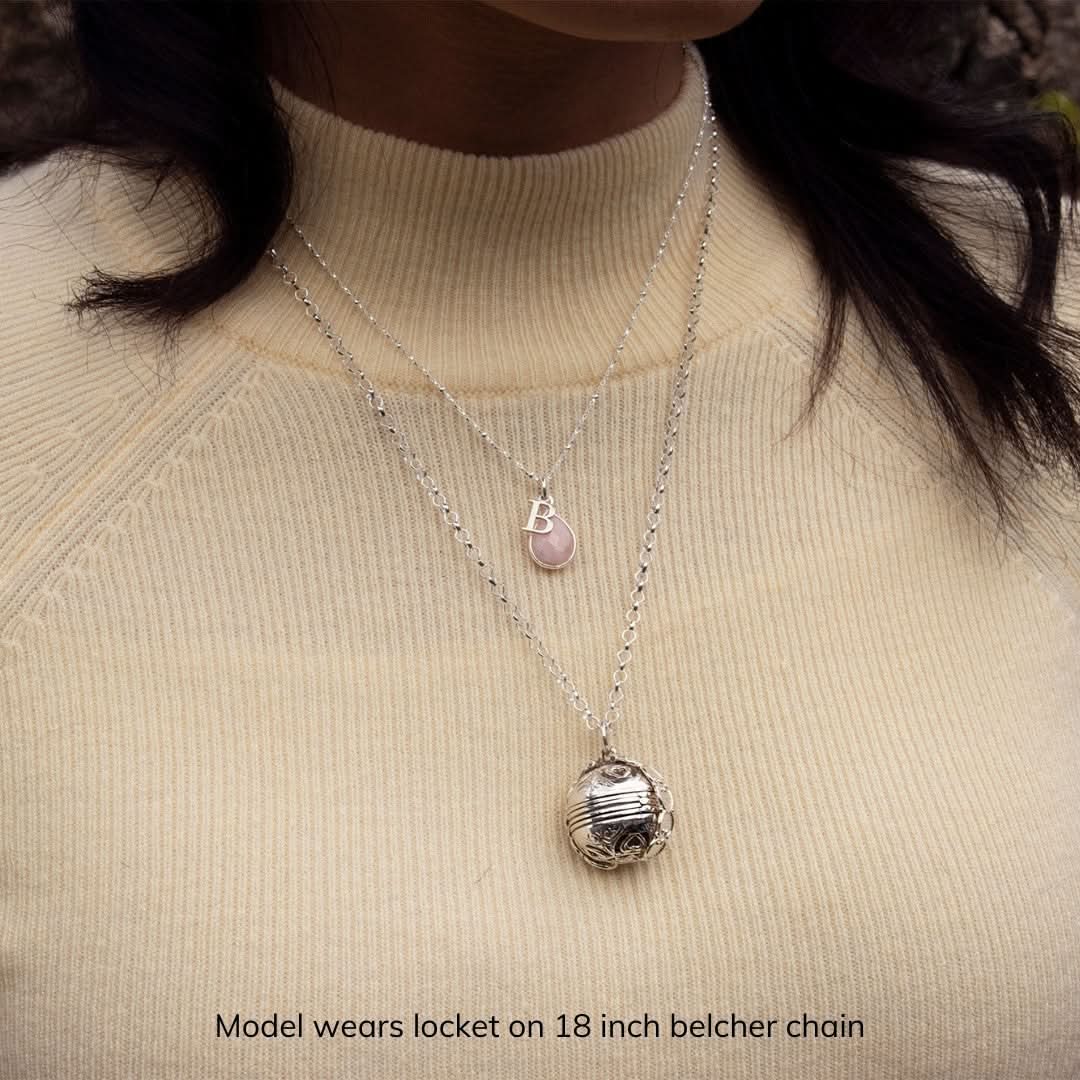 close up of model in cream top wearing silver memory keeper locket
