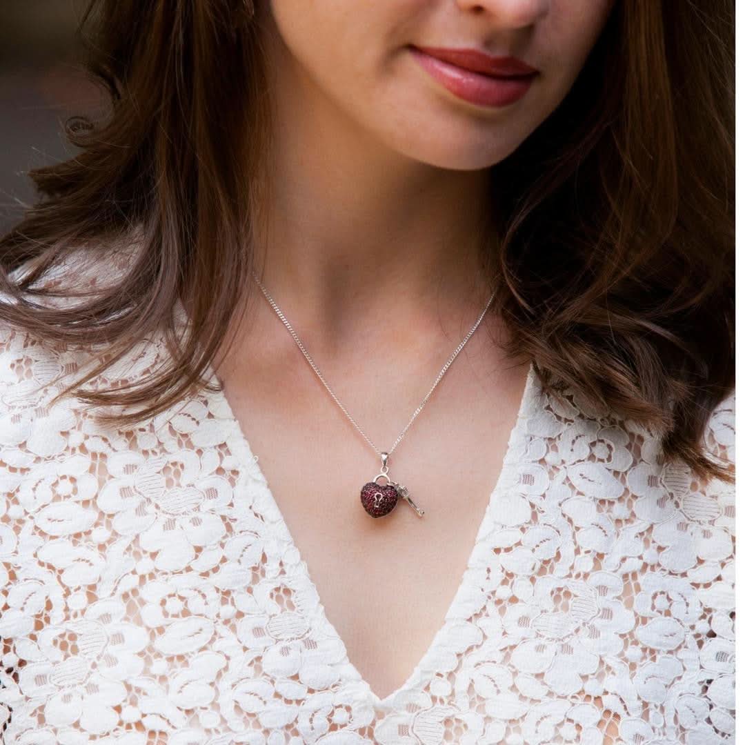 close up of model wearing key to my heart pendant in red